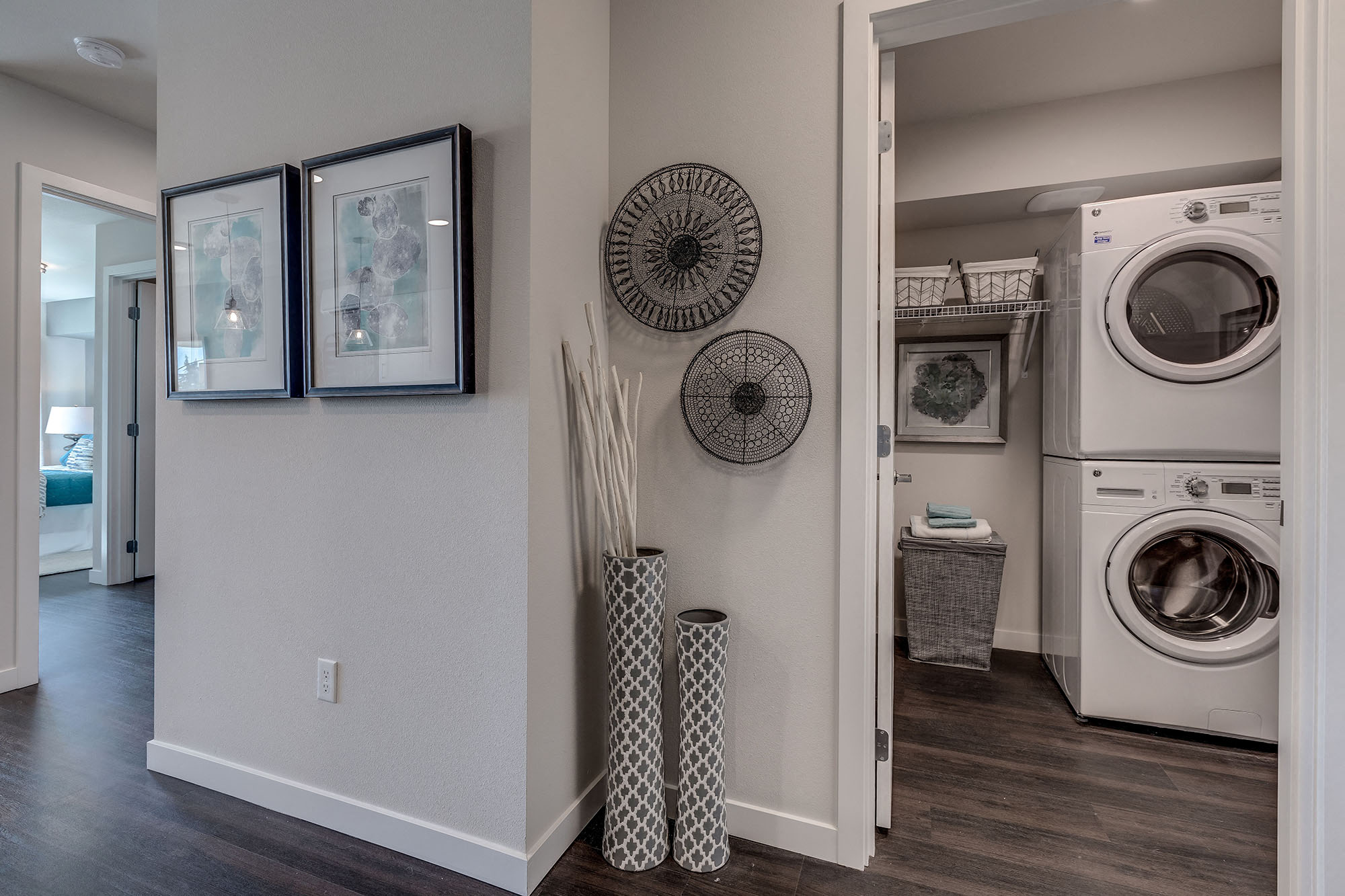 Lux Apartments Bellevue WA laundry room with front loading washer and dryer included and some added storage space